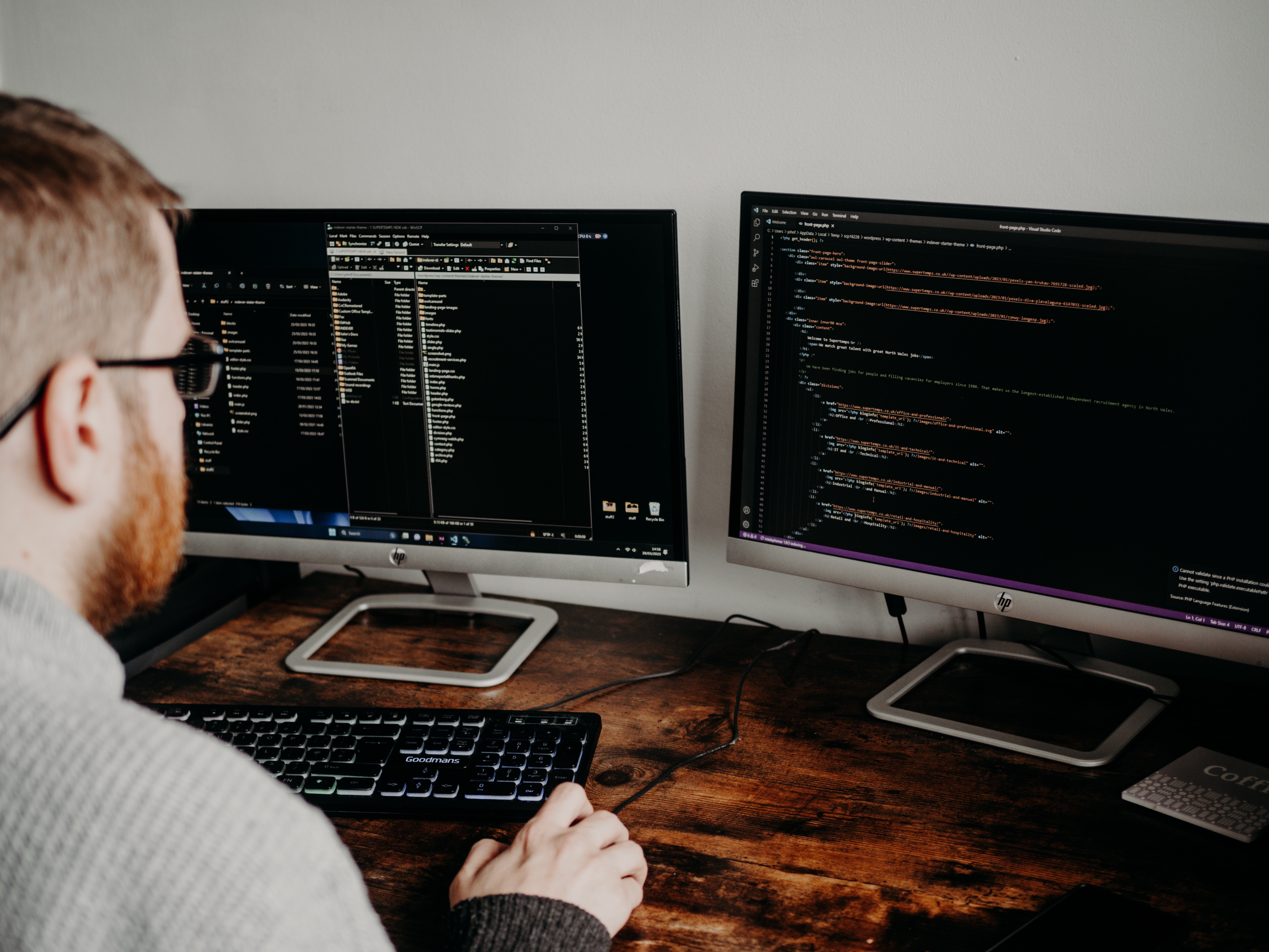 image of a man looking at code on screens conducting an IT audit 