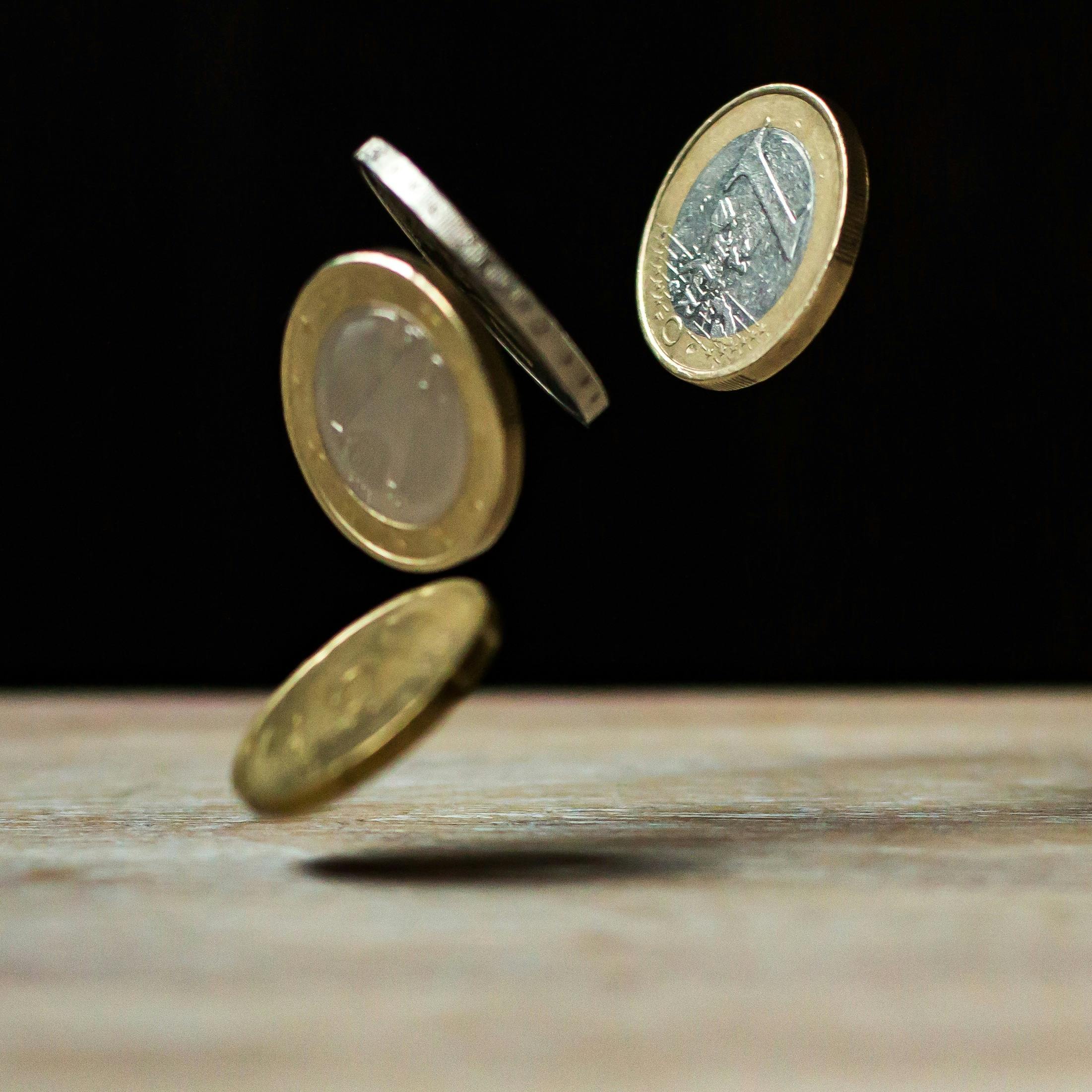 A group of falling british pound coins